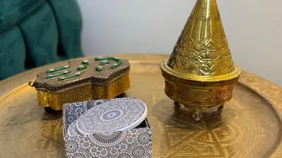 a table with a gold vase and a box on it at Mosaic 54 - Terrasse & Piscine chauffée - M Avenue in Marrakech