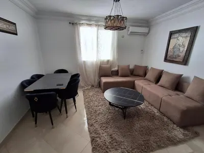 a living room with a couch and a table at Appartement a louer 2 chambres in Marrakech