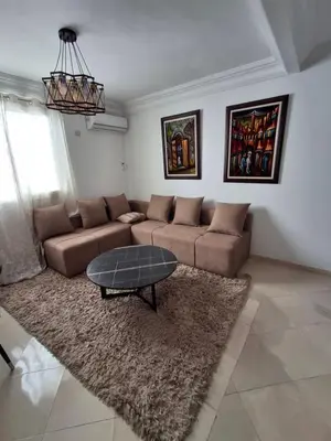 a living room with a couch and a table at Appartement a louer 2 chambres in Marrakech