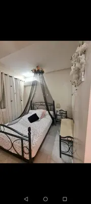 a bedroom with a bed with a mosquito net at Nilia in Marrakech
