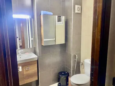 a small bathroom with a toilet and a sink at Charmant, terrasse intime, près du centre in Marrakech