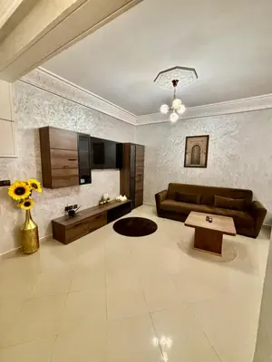 a living room with a couch and a table at Charmant, terrasse intime, près du centre in Marrakech