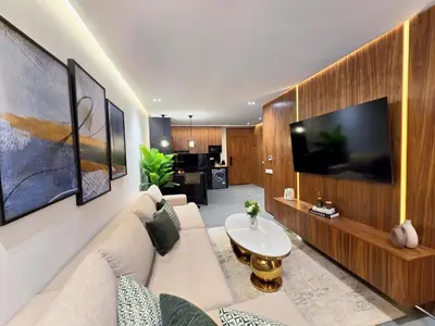 a living room with a couch and a large tv at Luxury & Modern Style 1BR, Gueliz-Steps from train in Marrakech