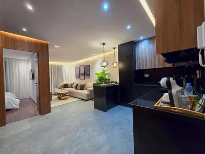 a kitchen and a living room with a couch at Luxury & Modern Style 1BR, Gueliz-Steps from train in Marrakech