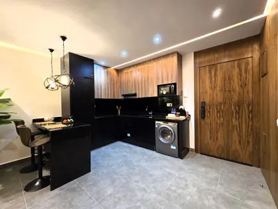 a laundry room with a washer and a washing machine at Luxury & Modern Style 1BR, Gueliz-Steps from train in Marrakech