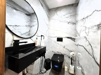 a bathroom with a black sink and a mirror at Luxury & Modern Style 1BR, Gueliz-Steps from train in Marrakech