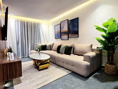 a living room with a couch and a table at Luxury & Modern Style 1BR, Gueliz-Steps from train in Marrakech