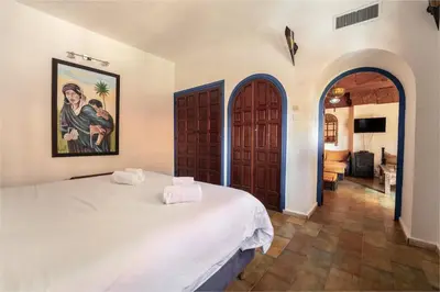 a bedroom with a white bed and an archway at Traditional, Cozy and Quiet Apartment, Pool, Palmeraie in Marrakech