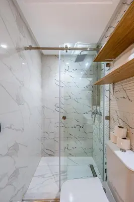 a bathroom with a shower with a toilet and a sink at Guéliz 7 Appartements in One Building in Marrakech