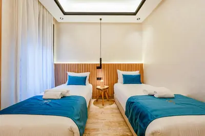 two beds in a room with blue and white at Guéliz 7 Appartements in One Building in Marrakech