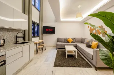 a kitchen and living room with a couch and a table at Guéliz 7 Appartements in One Building in Marrakech
