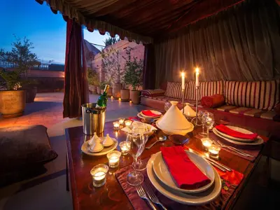 a living room with a table with plates and wine glasses at Riad Darhani - Private use option - in Marrakech