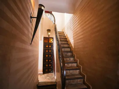 a staircase in a house with a light at the top at Riad Darhani - Private use option - in Marrakech