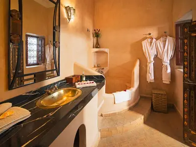 a bathroom with a sink and a tub at Riad Darhani - Private use option - in Marrakech