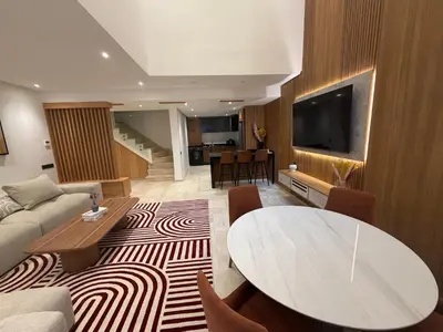 a living room with a couch and a table at Appartement duplex haut standing Guelyz in Marrakech
