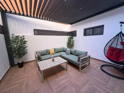a living room with a couch and a table at Appartement duplex haut standing Guelyz in Marrakech