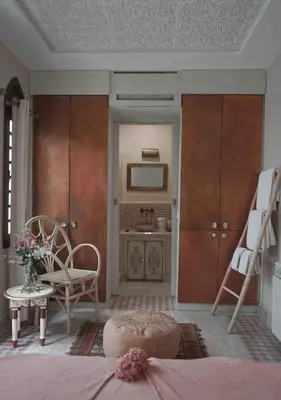 a bedroom with a bed and a chair and a desk at Riad Beata - Private use option - in Marrakech