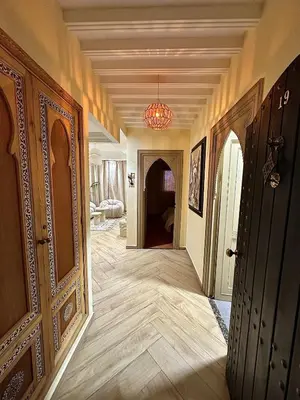 a hallway of a house with a chandelier at Downtown Feng Shui-style apartment with mountain view in Marrakech