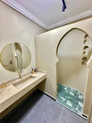 a bathroom with a sink and a mirror at Downtown Feng Shui-style apartment with mountain view in Marrakech