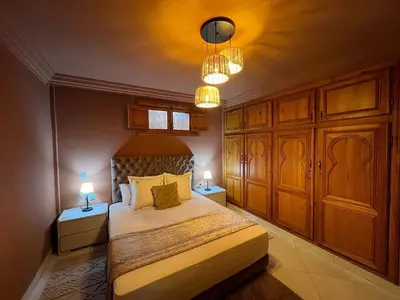 a bedroom with a bed with two night stands and two lamps at Le Patio Marrakchi in Marrakech