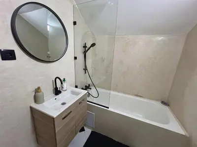 a bathroom with a sink and a tub and a mirror at Le Patio Marrakchi in Marrakech