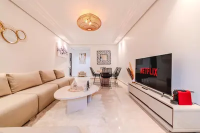a living room with a couch and a flat screen tv at New Luxury Downtown Apart Marrakech 3BR Terraces in Marrakech
