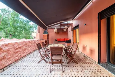 a patio with a table and chairs and a couch at New Luxury Downtown Apart Marrakech 3BR Terraces in Marrakech