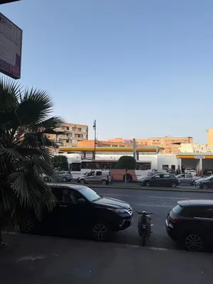 a parking lot with cars parked next to a parking meter at Modern Flat Gueliz ,City center Marrakech in Marrakech