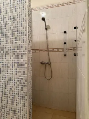 a bathroom with a shower with blue and white tiles at Modern Flat Gueliz ,City center Marrakech in Marrakech