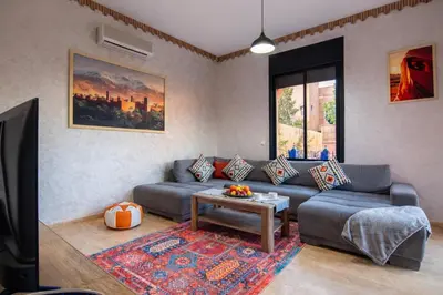 a living room with a couch and a table at Villa Familiale, Piscine et jardin privés, proche du centre ville in Marrakech