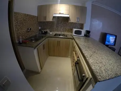 a kitchen with wooden cabinets and a counter top at Étoile de marrakech in Marrakech