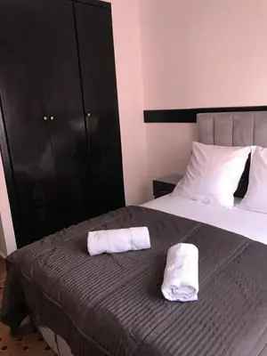a bedroom with two white towels on a bed at Résidence avec piscine &salle de sport a la palmeraie À 10minutes du Madina Marrakech in Marrakech