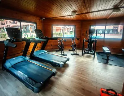 a gym with several exercise bikes in a room at Résidence avec piscine &salle de sport a la palmeraie À 10minutes du Madina Marrakech in Marrakech