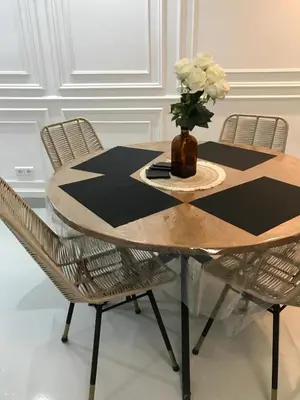 a dining room table with a vase of flowers on it at Résidence avec piscine &salle de sport a la palmeraie À 10minutes du Madina Marrakech in Marrakech