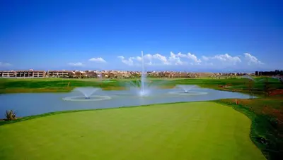 a pond with a fountain in the middle of a golf course at Luxury Apartments in Marrakech