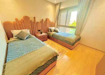 a bedroom with two beds and a window at Luxury Apartments in Marrakech