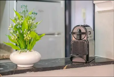 a hair dryer and a vase with flowers on a counter at Cocon Chic et Élégant Quartier Hivernage in Marrakech