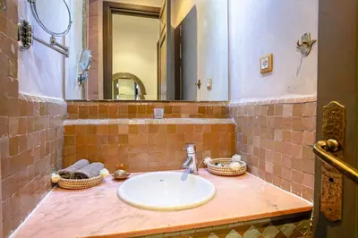 a bathroom with a sink and a mirror at Marrakech Palmeraie 3, 2-bedroom appartement, ,res with pool in Marrakech