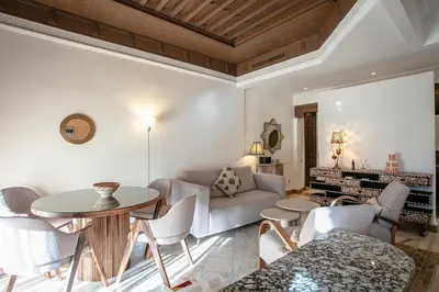 a living room with a couch and a table and chairs at Marrakech Palmeraie 3, 2-bedroom appartement, ,res with pool in Marrakech
