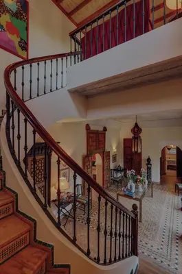 a spiral staircase in a house with a living room at Casa Memoria Marrakech in Marrakech