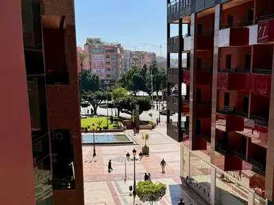 a view of a city with people walking around a courtyard at Modern apartment in Gueliz Plaza in Marrakech