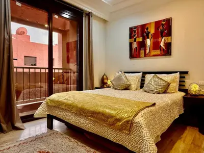 a bedroom with a bed and a large window at Moroccan style Soltana pool & central internet in Marrakech