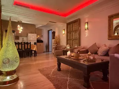 a living room with a couch and a table at Moroccan style Soltana pool & central internet in Marrakech