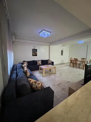 a living room with a couch and a table at Apartment in Gueliz in Marrakech