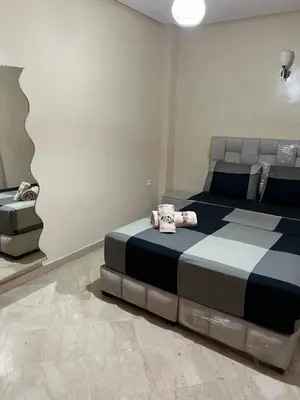 a bedroom with a bed and a mirror at Apartment in Gueliz in Marrakech