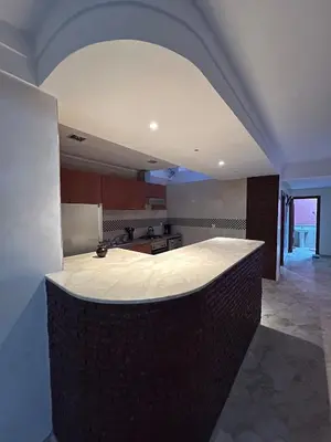 a kitchen with a large island in the middle of a room at Apartment in Gueliz in Marrakech