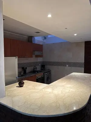a kitchen with a large marble counter top in it at Apartment in Gueliz in Marrakech
