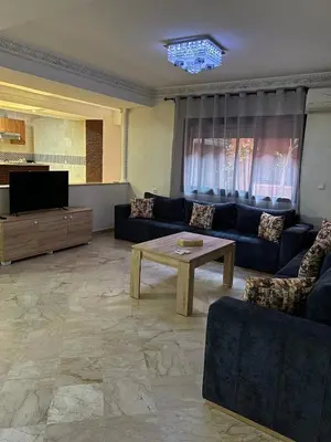a living room with a couch and a coffee table at Apartment in Gueliz in Marrakech