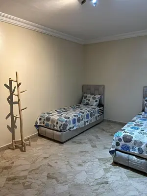 a bedroom with two beds in a room at Apartment in Gueliz in Marrakech