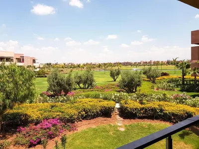a view of a garden from a balcony at Luxury Apartments in Marrakech